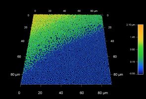 Precious opals are composed of closely packed silica spheres with sizes of several hundred nanometers. The beautiful colors of opals are caused by light diffraction and interference. This 90 micron AFM scan shows an opal surface with two transitions between neighboring planes of nanospheres.